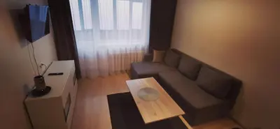 a small living room with a couch and a table at Lauros 1 & R Apartamentai in Panevėžys