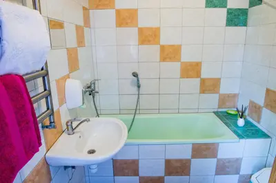 a bathroom with a sink and a bath tub at Eiva in Marijampolė