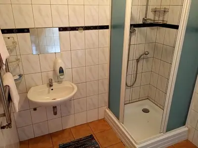 a bathroom with a sink and a shower at Eiva in Marijampolė