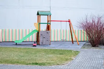 a playground with a slide and a swing set at Hygge Oasis for family with free parking and wi fi in Vilnius