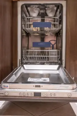 a dishwasher with a dish rack with dishes in it at Hygge Oasis for family with free parking and wi fi in Vilnius
