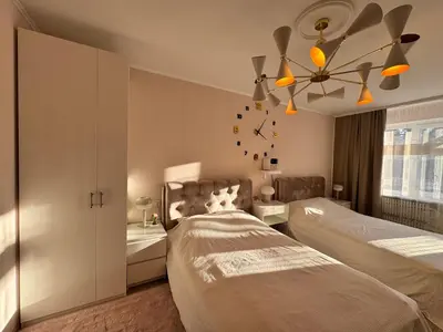 a bedroom with two beds and a ceiling fan at AUKŠTAS Ap in Visaginas