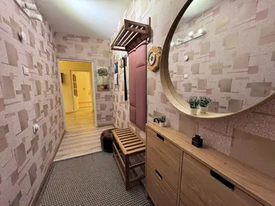 a bathroom with a large mirror and a sink at AUKŠTAS Ap in Visaginas