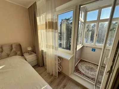 a bedroom with a bed and a large window at AUKŠTAS Ap in Visaginas