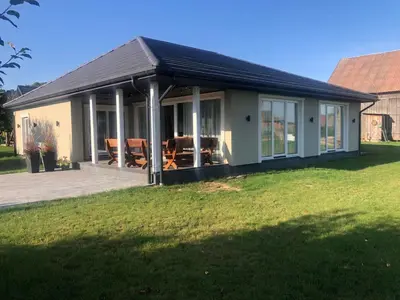 a house with a large screened in porch at Wind Mood in Klebiškis
