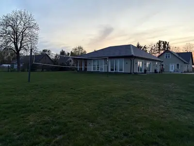 a house in a field with a soccer ball at Wind Mood in Klebiškis