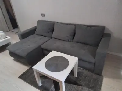 a living room with a couch and a coffee table at Svečių butas in Šiauliai