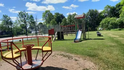 a park with a playground with a slide at Kambarys Šiaurėje in Kaltanėnai