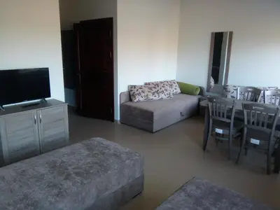 a living room with a couch and a table at Kambarys Šiaurėje in Kaltanėnai