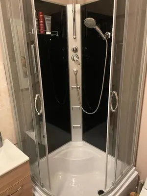 a shower with a glass door in a bathroom at MM Apartments in Kaunas