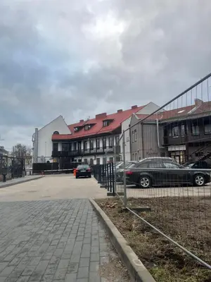 a parking lot with cars parked in front of buildings at MM Apartments in Kaunas