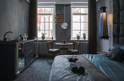 a bedroom with a bed and a sink and a table at Old Town Hideaway in Vilnius