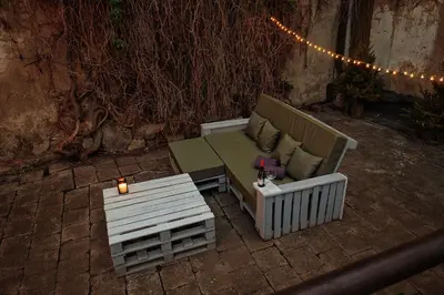 a couch and a table on a brick patio at Old Town Hideaway in Vilnius
