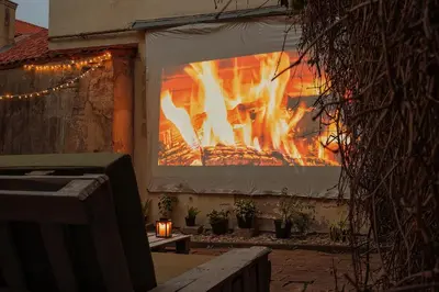 a large screen with a fire in a building at Old Town Hideaway in Vilnius