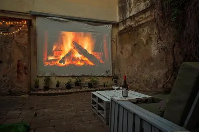 a screen with a fire in a room at Old Town Hideaway in Vilnius