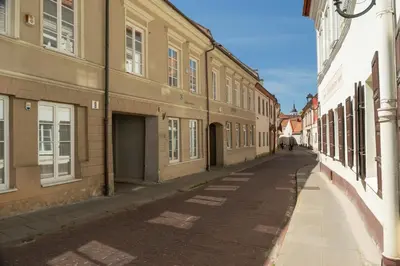 an empty street in a city with buildings at Old Town Hideaway in Vilnius
