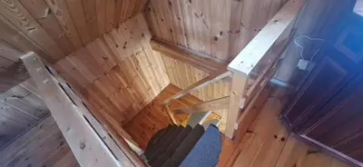 an overhead view of a wooden cabin with a staircase and a room at Gėlūnų sodyba in Gelunai