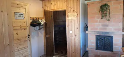 a room with a door and a brick wall at Gėlūnų sodyba in Gelunai