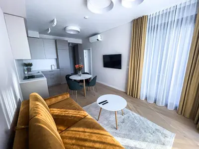 a living room with a couch and a table at Parko Aveniu Apartamentai B2 in Birštonas