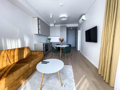 a living room with a couch and a table at Parko Aveniu Apartamentai B2 in Birštonas