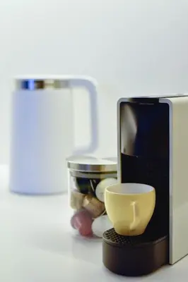 a microwave with a coffee cup on a counter at Parko Aveniu Apartamentai B2 in Birštonas