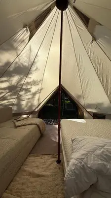 a tent with two beds in a room at Glamping under the pines in Vilnius
