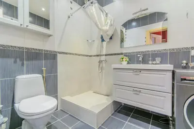 a white bathroom with a toilet and a sink at Glamping under the pines in Vilnius