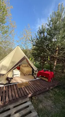 a tent is set up on a wooden deck at Glamping under the pines in Vilnius