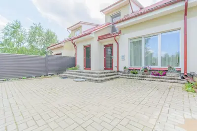 a house with a brick driveway in front of it at Glamping under the pines in Vilnius