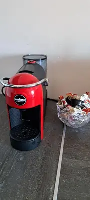a red toaster sitting next to a bowl of food at Vita apartment in Vilnius