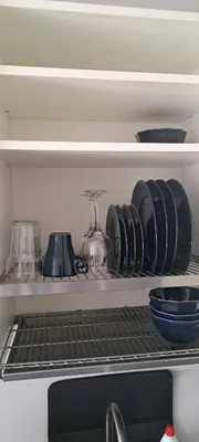 a shelf with plates and other dishes on it at Vita apartment in Vilnius