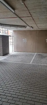 an empty parking lot with numbers on the wall at Vita apartment in Vilnius