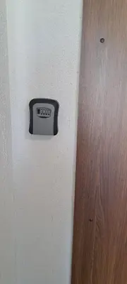 a clock on a wall next to a door at Vita apartment in Vilnius