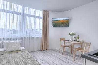 a white room with a table and a dining room at Old Town Edvin Apartments in Vilnius