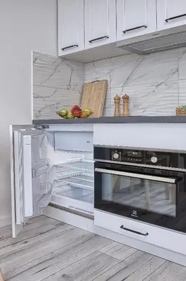 an empty kitchen with an open oven with food in it at Old Town Edvin Apartments in Vilnius