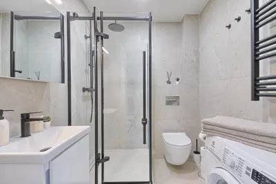 a bathroom with a shower and a toilet and a sink at Old Town Edvin Apartments in Vilnius