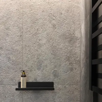 a bottle of wine sitting on a shelf on a wall at Spacious luxury apartment with parking in Vilnius