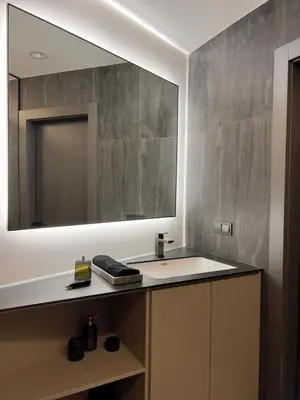 a bathroom with a sink and a mirror at Spacious luxury apartment with parking in Vilnius