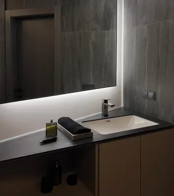 a bathroom with a white sink and a mirror at Spacious luxury apartment with parking in Vilnius