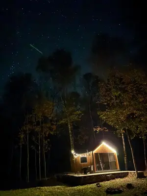 a cabin under a starry sky at night at Here & Now Tiny House in Sudvariškės