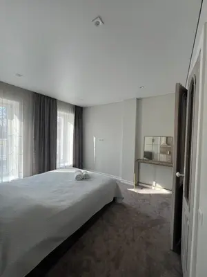 a bedroom with a large bed and a large window at Sigita in Šveicarija