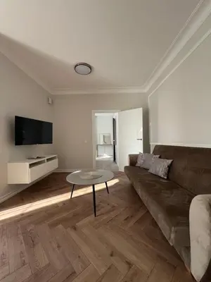 a living room with a couch and a table at Sigita in Šveicarija