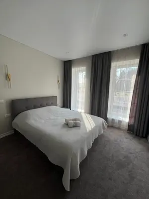 a bedroom with a white bed with two towels on it at Sigita in Šveicarija