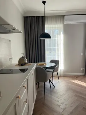 a kitchen with a table and chairs and a dining room at Sigita in Šveicarija