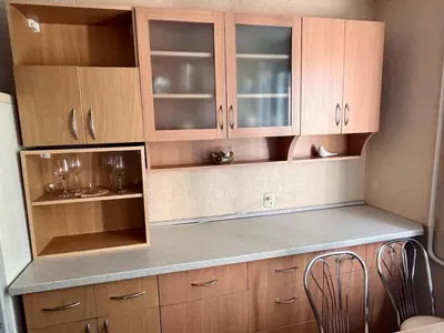 a kitchen with wooden cabinets and a counter top at Apartment in the city Kaunas in Kaunas