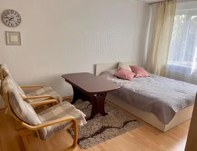 a bedroom with a bed and a table and chairs at Apartment in the city Kaunas in Kaunas
