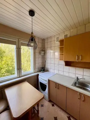 a kitchen with a sink and a table in it at Apartment in the city Kaunas in Kaunas