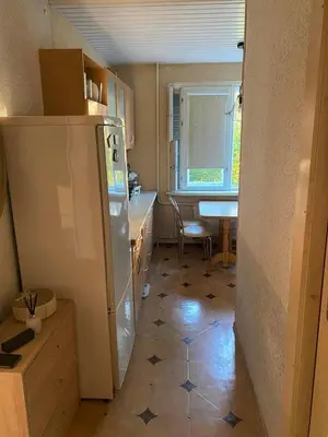 a kitchen with a refrigerator and a table in it at Apartment in the city Kaunas in Kaunas