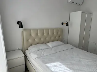 a bedroom with a bed with a white bedspread at Užupio apartamentai Nemokamas parkingas in Vilnius