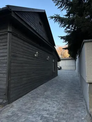 a large wooden garage door on the side of a building at Užupio apartamentai Nemokamas parkingas in Vilnius